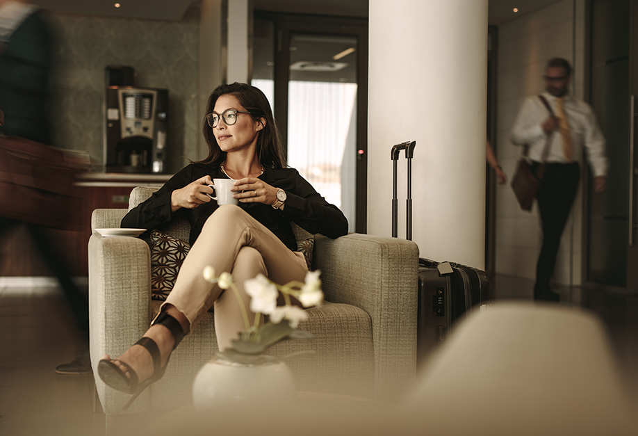 woman sitting next to a suitcase