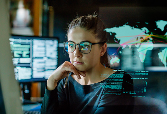woman with glasses looking at data