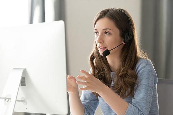 woman at her computer with a headset