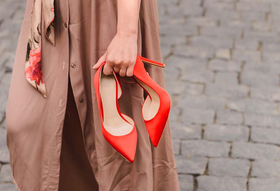 woman holding her high heels